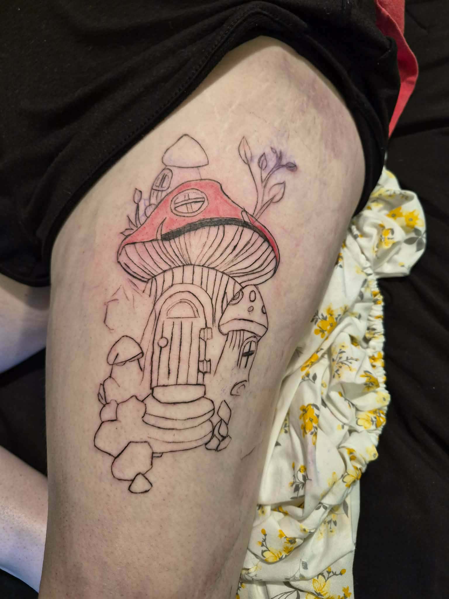 Mushroom fairy house tattoo on thigh — whimsical linework